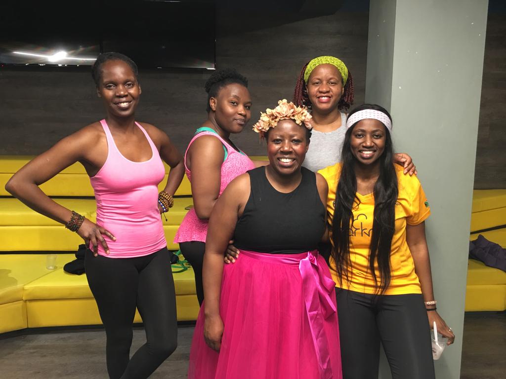Beatrice, in a pink tutu, Life Child champion standing together with her friends